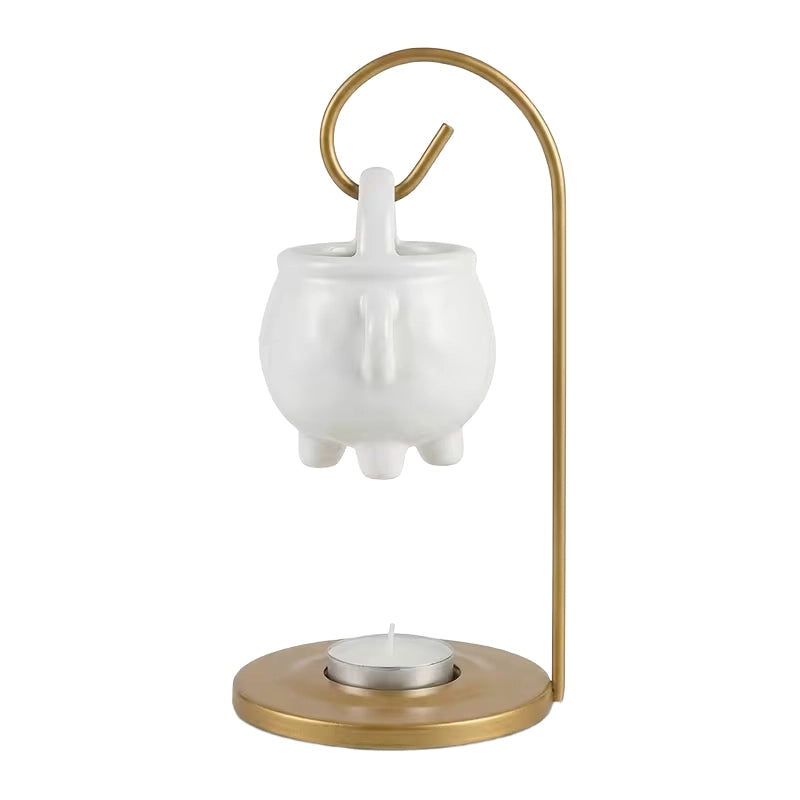 White ceramic teapot with a gold handle and base on a white background